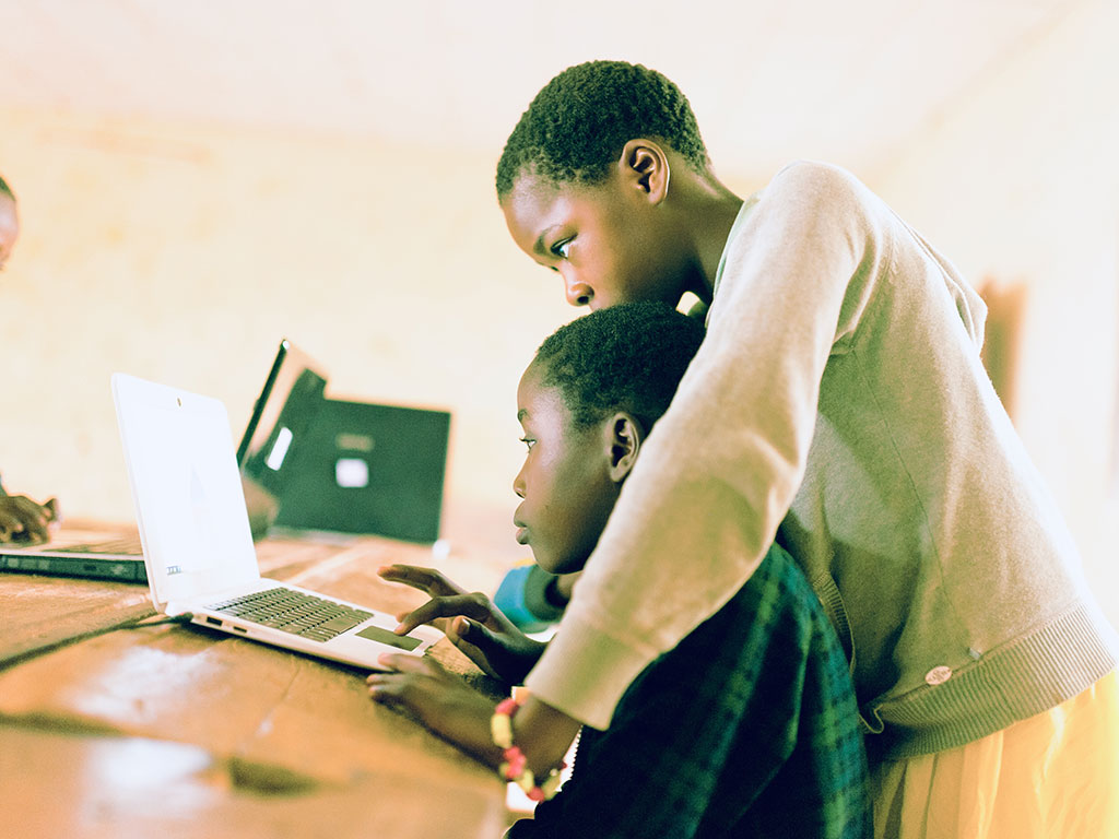 Two students learning at a laptop
