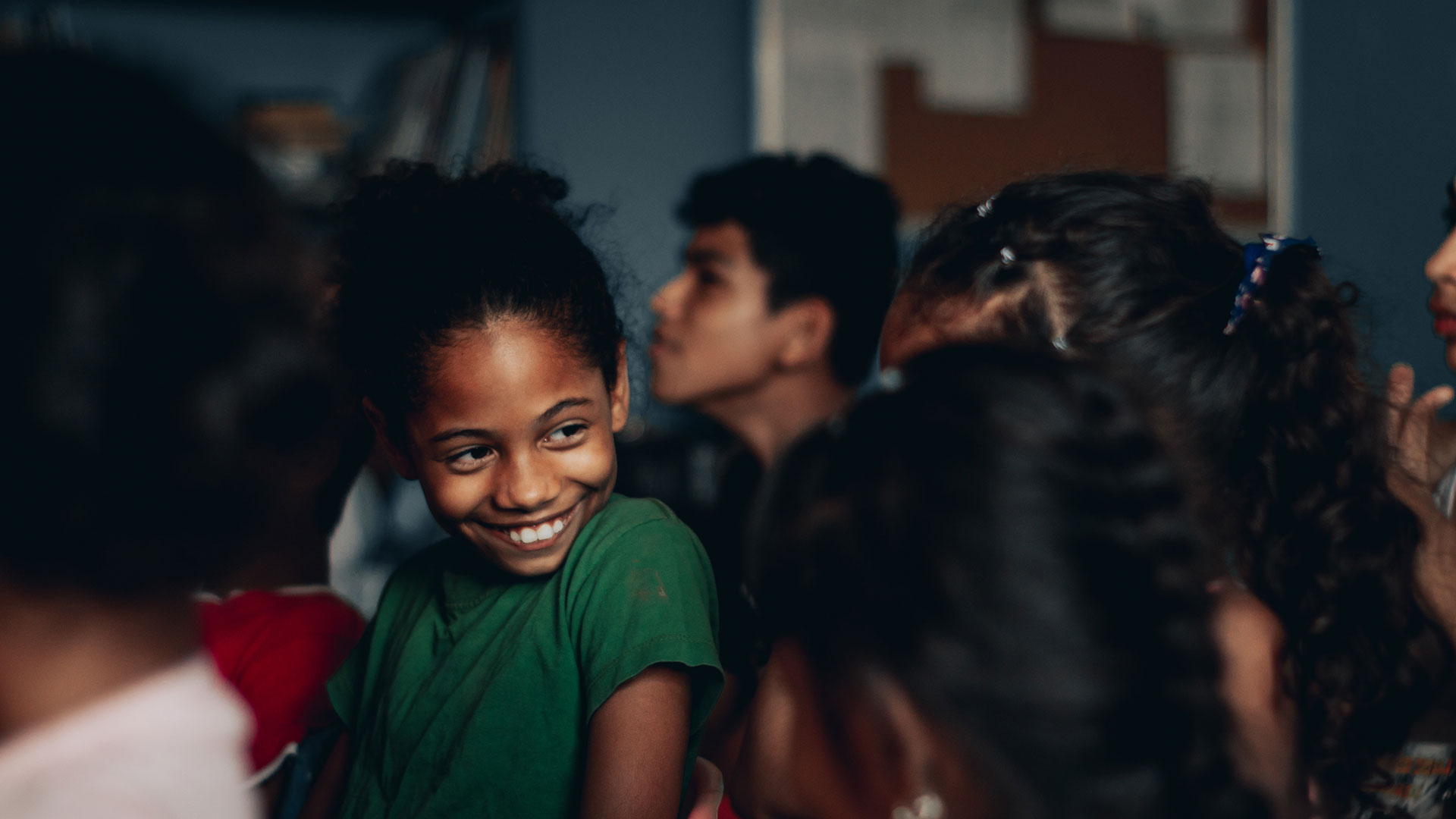 A young student smiling among her classmates