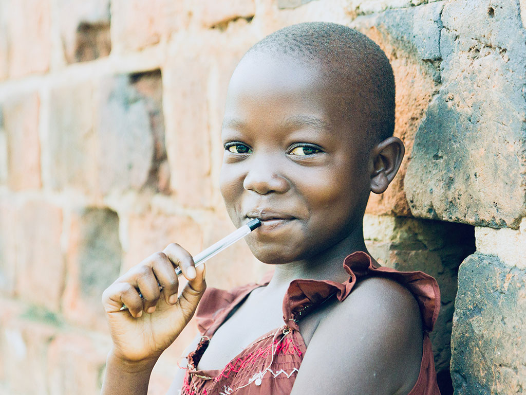 A young girl with a pen, ready to learn